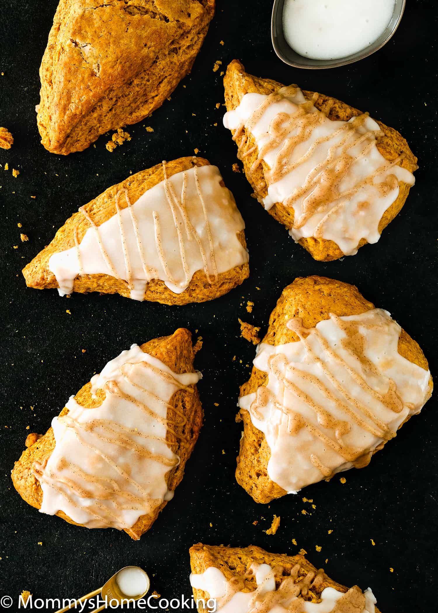Overhead view of Eggless Pumpkin Chai Scones with a glaze.