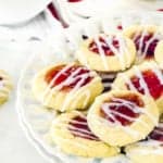 EGGLESS THUMBPRINT COOKIES on a plate drizzled with glaze