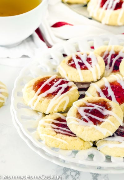 EGGLESS THUMBPRINT COOKIES on a plate drizzled with glaze