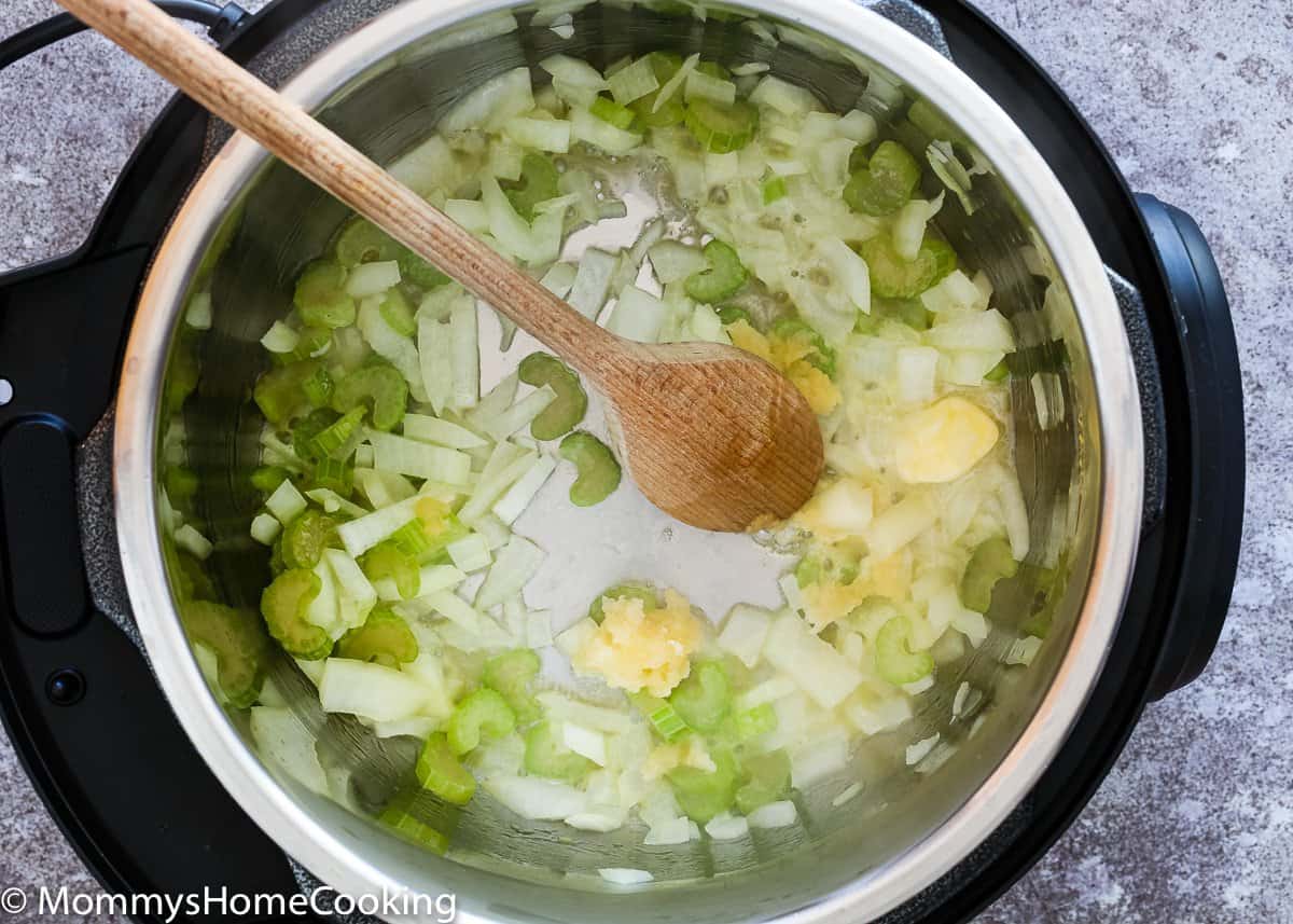 onion, garlic and celery in a pressure cooker pot