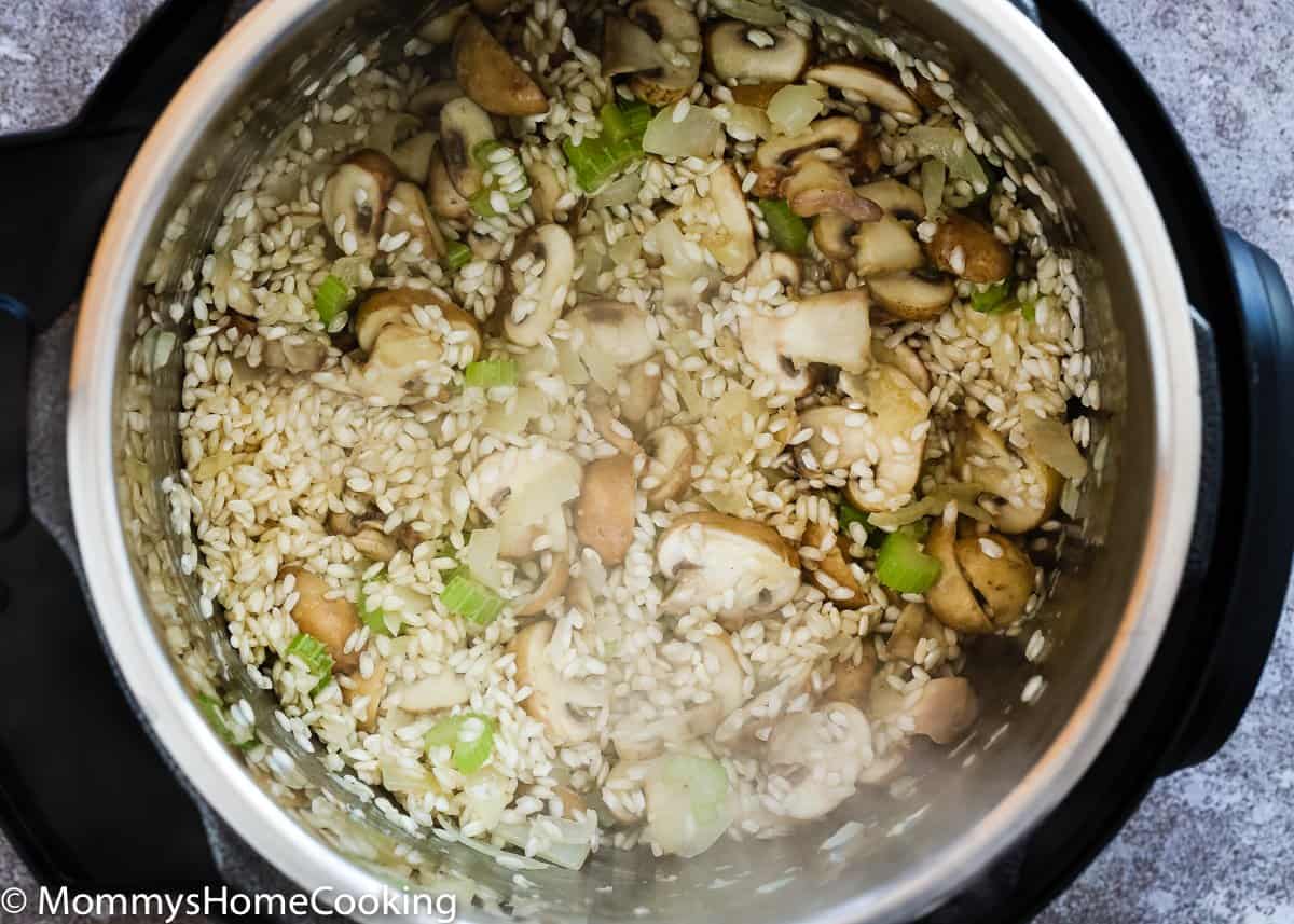 onion, garlic, celery, mushroom and rice in a pot