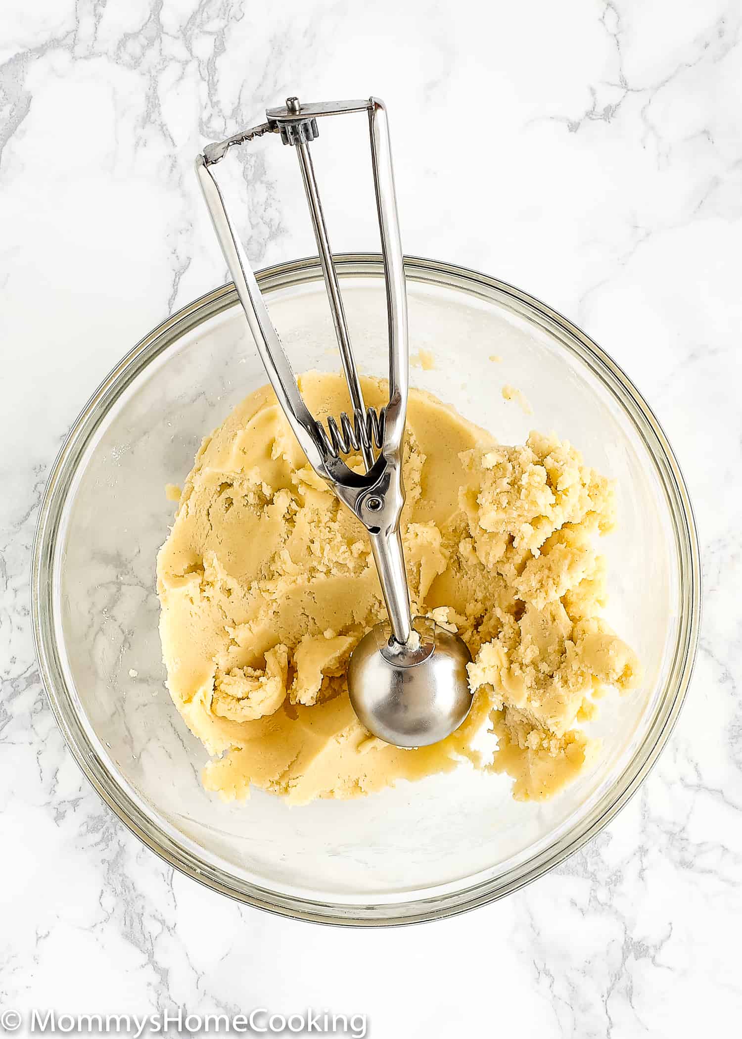 Eggless Thumbprint Cookie dough on a bowl with an cookie dough scoop.