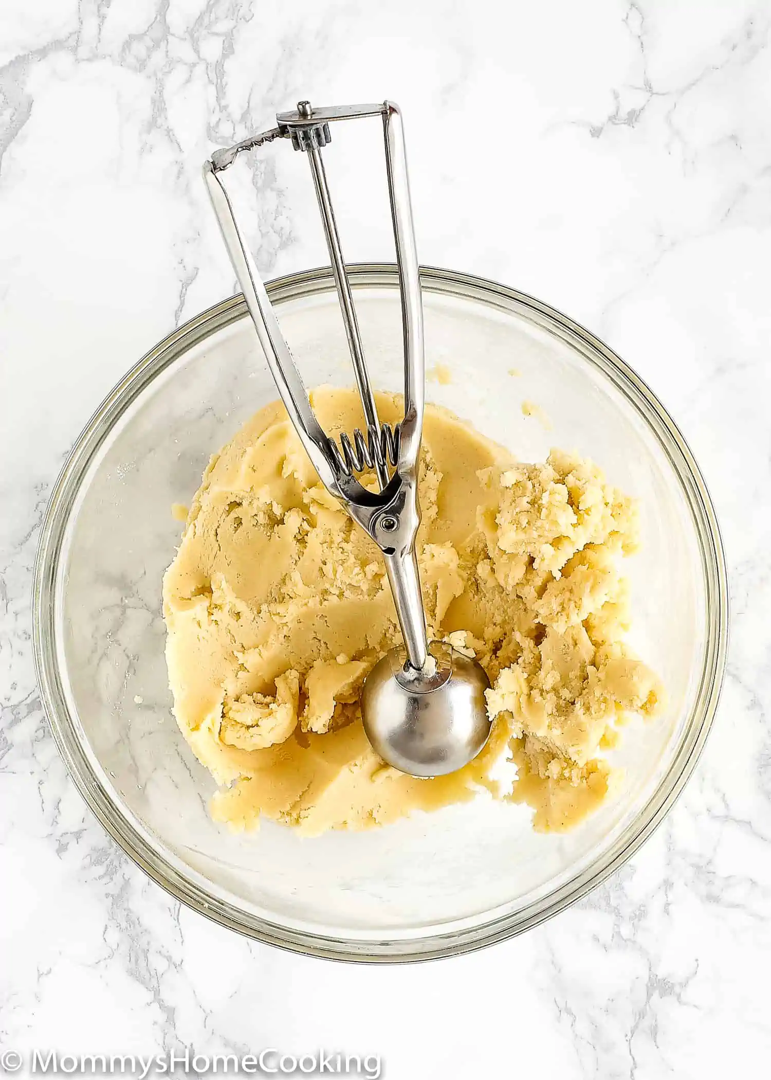 Eggless Thumbprint Cookie dough on a bowl with an ice cream scoop 