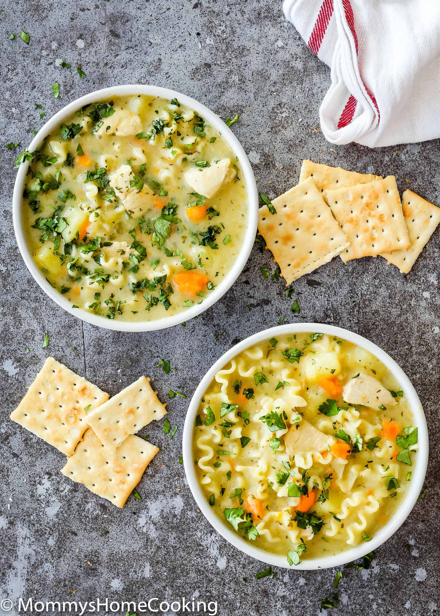two bowls of Chicken Noodle Soup with cracker on the side.