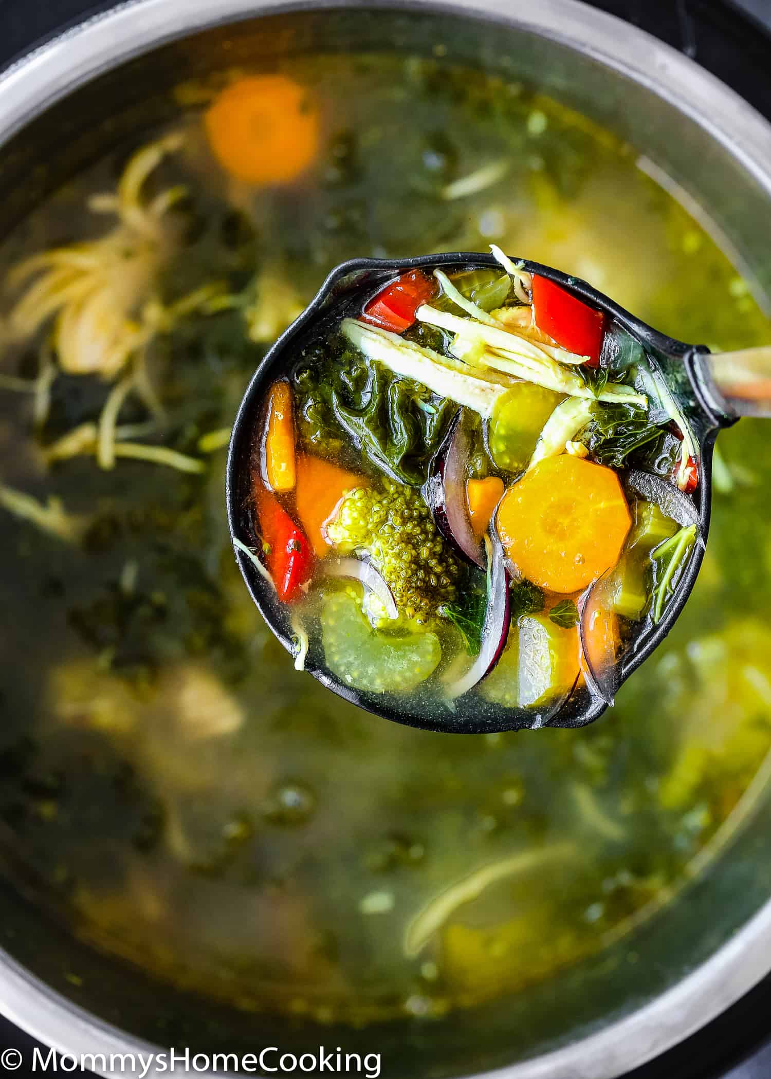 a serving spoon with detox soup.