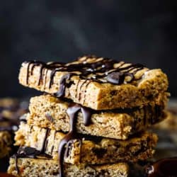 Stack of Homemade Healthy Eggless Energy Bars drizzled with chocolate.