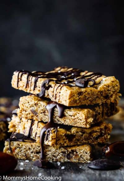 Stack of Homemade Healthy Eggless Energy Bars drizzled with chocolate.