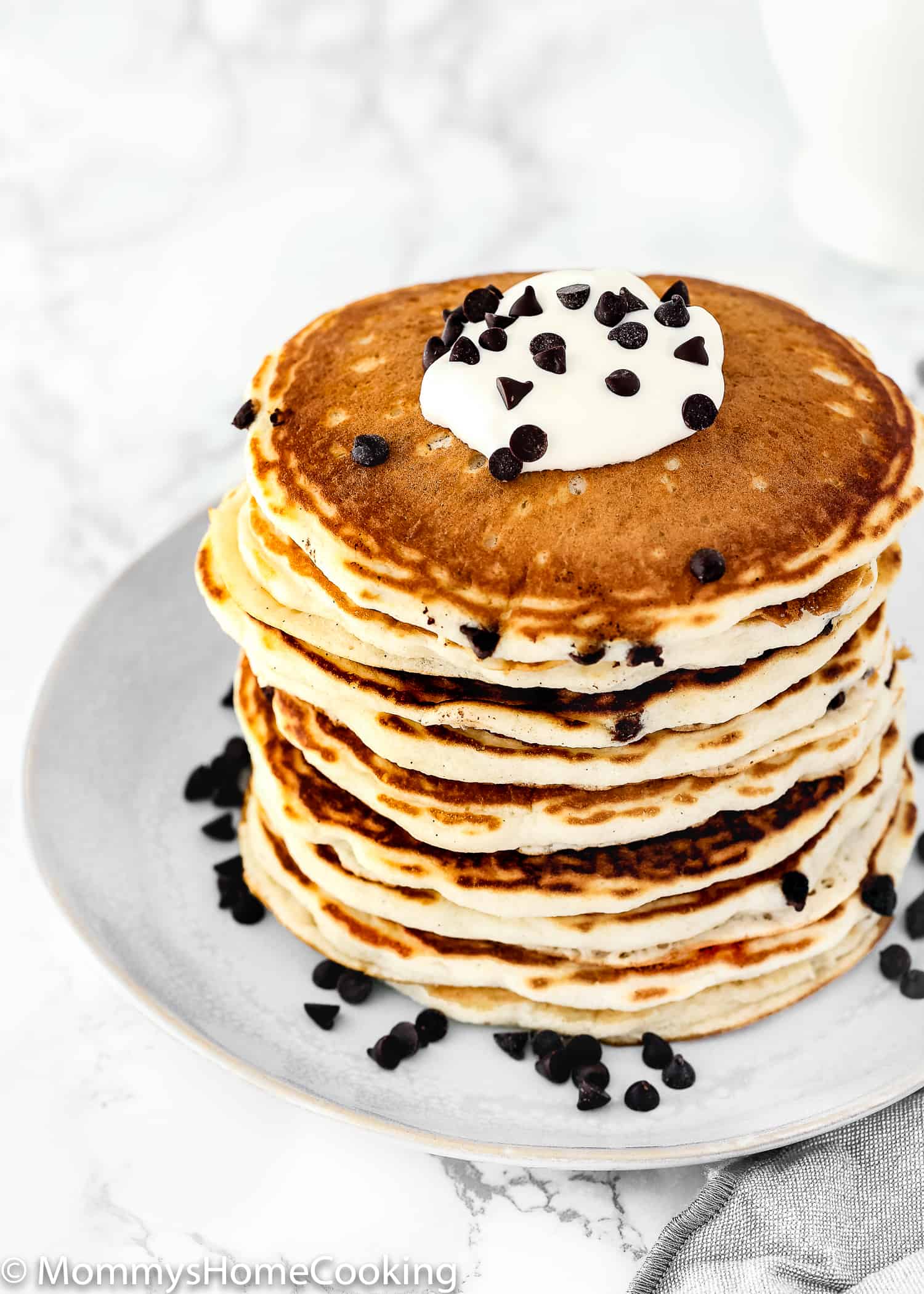 stack of egg-free dances with whipped cream and chocolate chips on top.