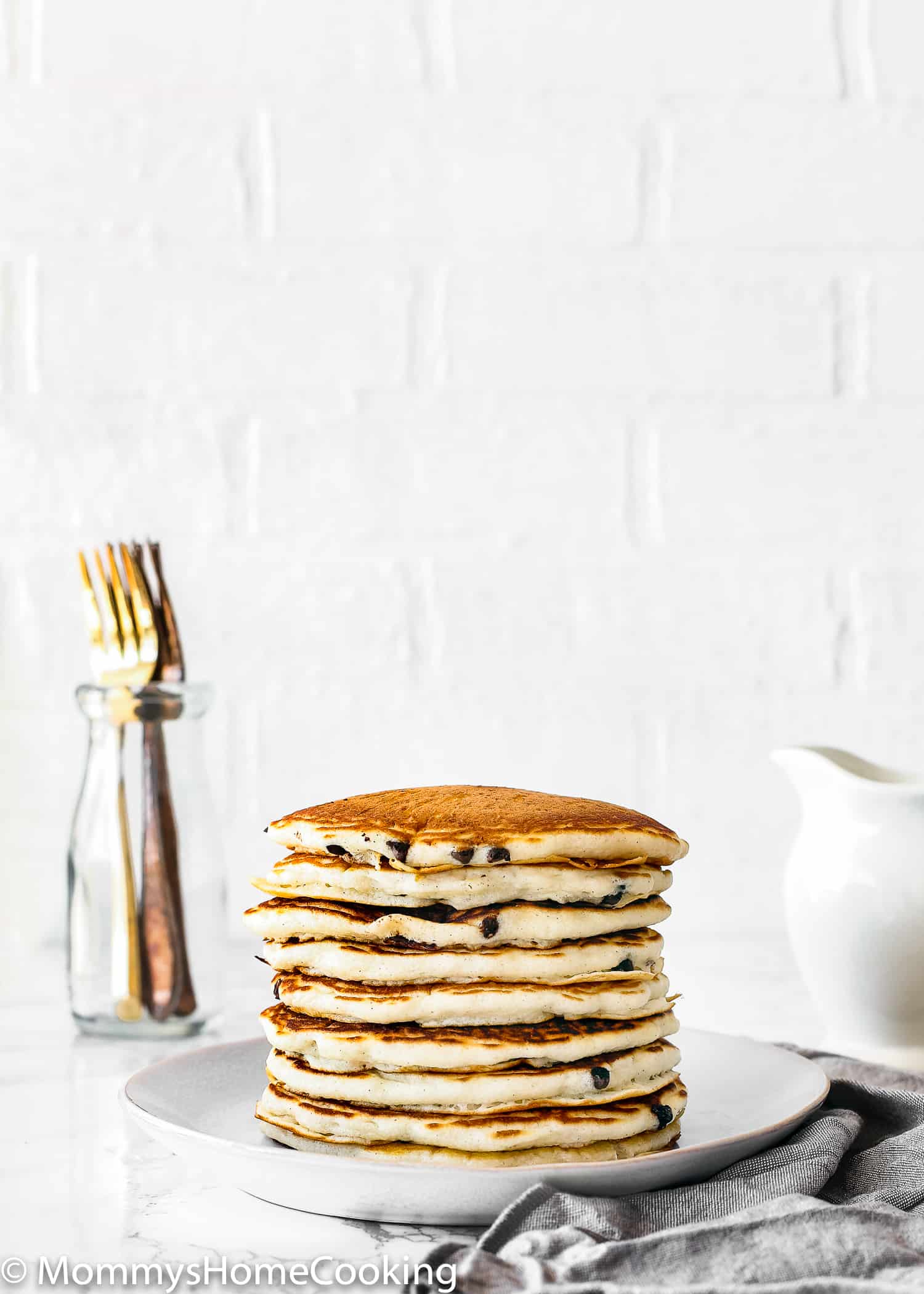 stack of chocolate chip pancakes on  plate.