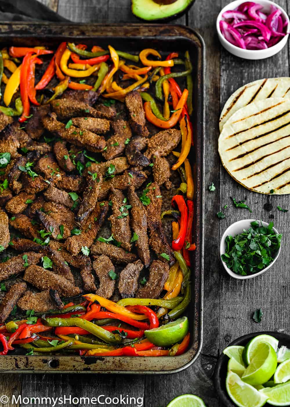 This Easy Sheet Pan Beef Fajitas is zesty, bright, and mess-free! The secret lies in a flavorful marinade. Seasoned beef is oven-broiled on a sheet pan with a mixture of peppers and onions. https://mommyshomecooking.com
