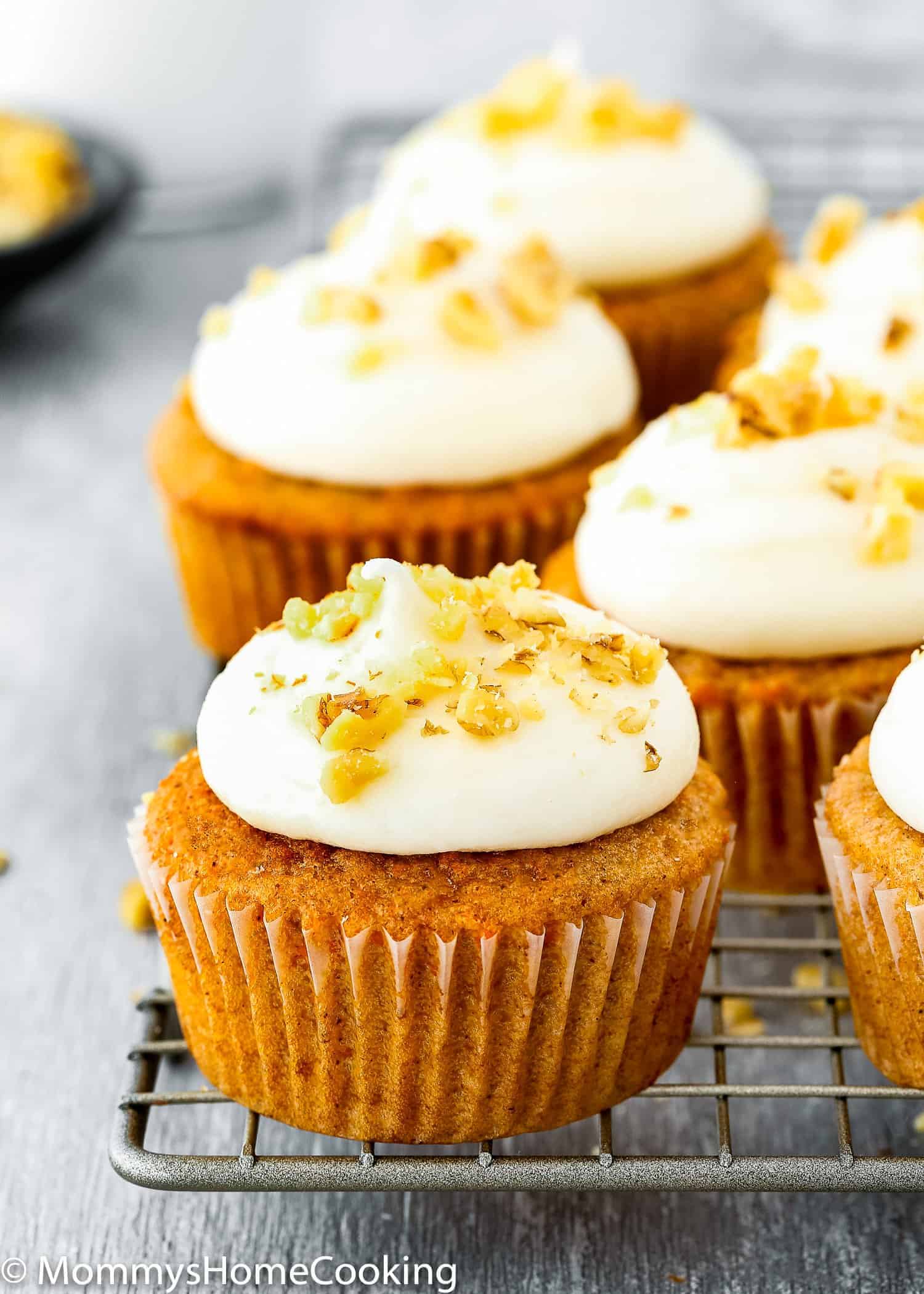 carrots cupcakes over a cooling rack.