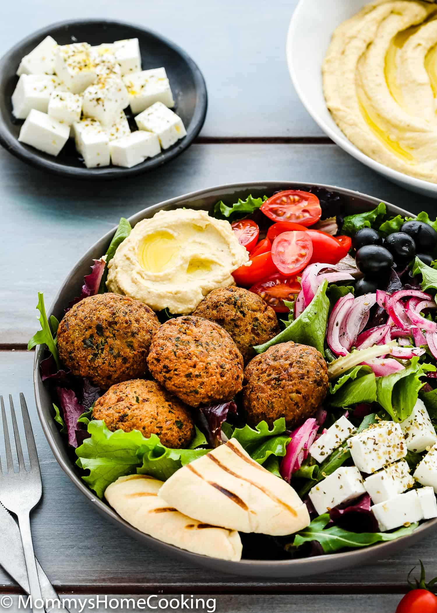 Falafel Salad Bowls with Mustard Hummus and cubed feta cheese in the background.