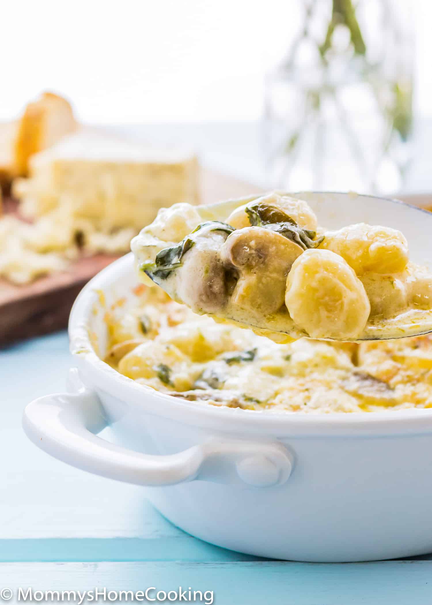 Cheesy Gnocchi and mushrooms in a serving spoon