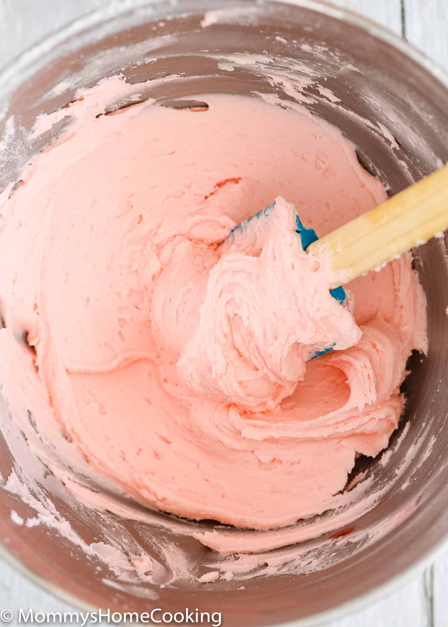 Pink buttercream frosting in a bowl