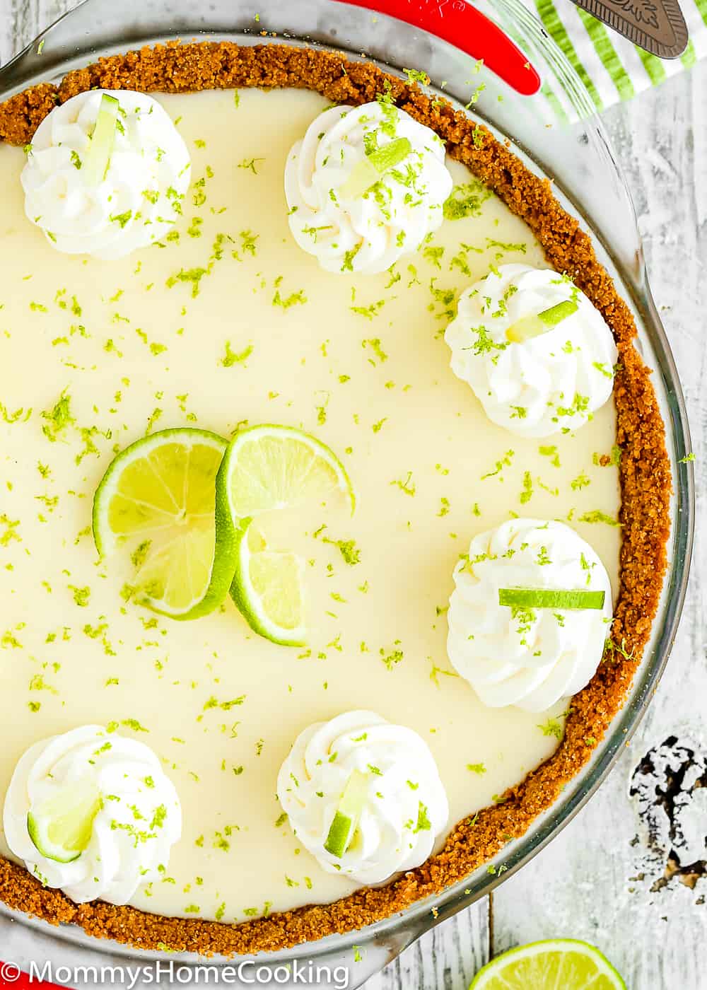 eggless key lime pie decorated with whipped cream in a pie dish close-up