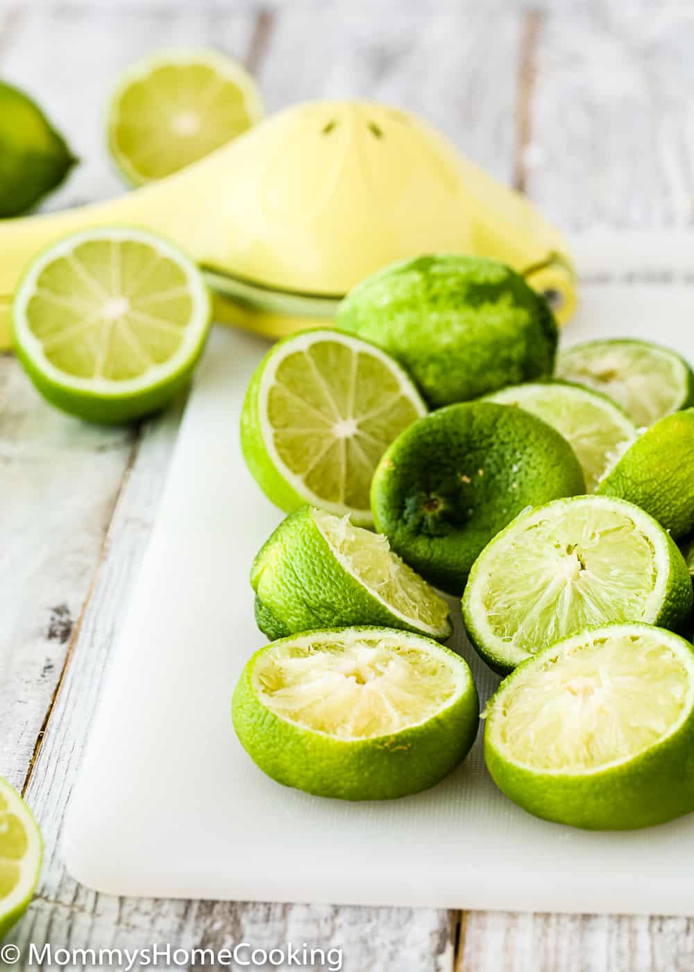 many squeezed limes over a cutting board