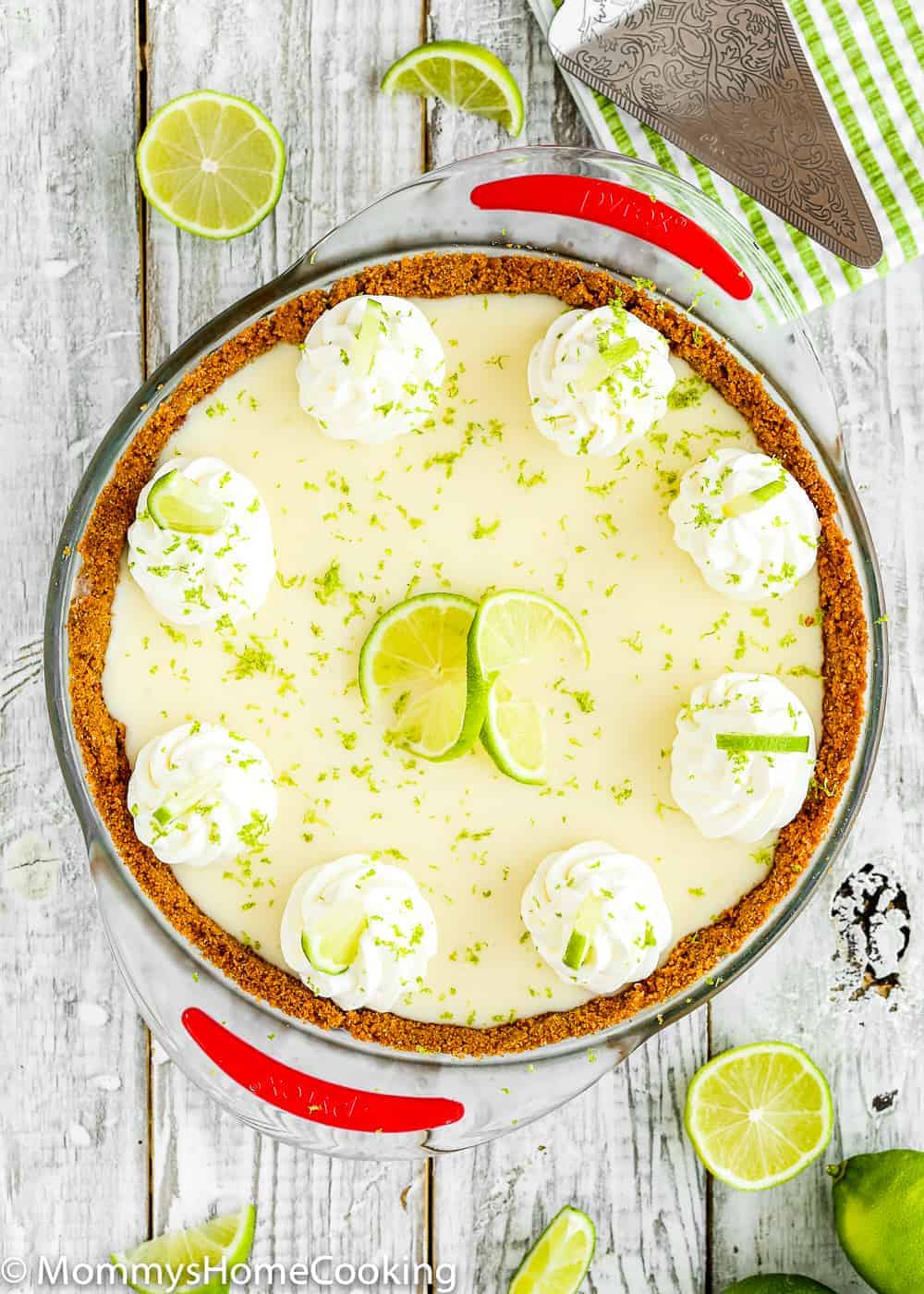 eggless key lime pie decorated with whipped cream in a pie dish