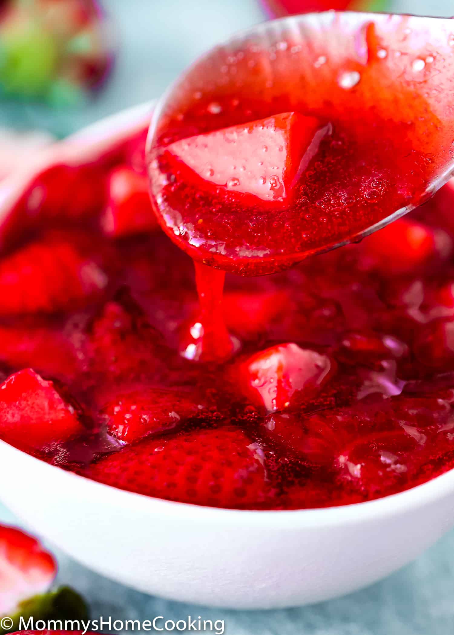 strawberry sauce/topping  in a spoon close-up