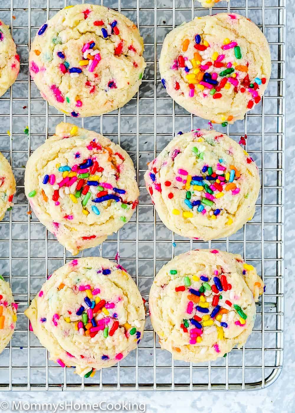 Soft and tender eggless funfetti cookies in a cooling rack.