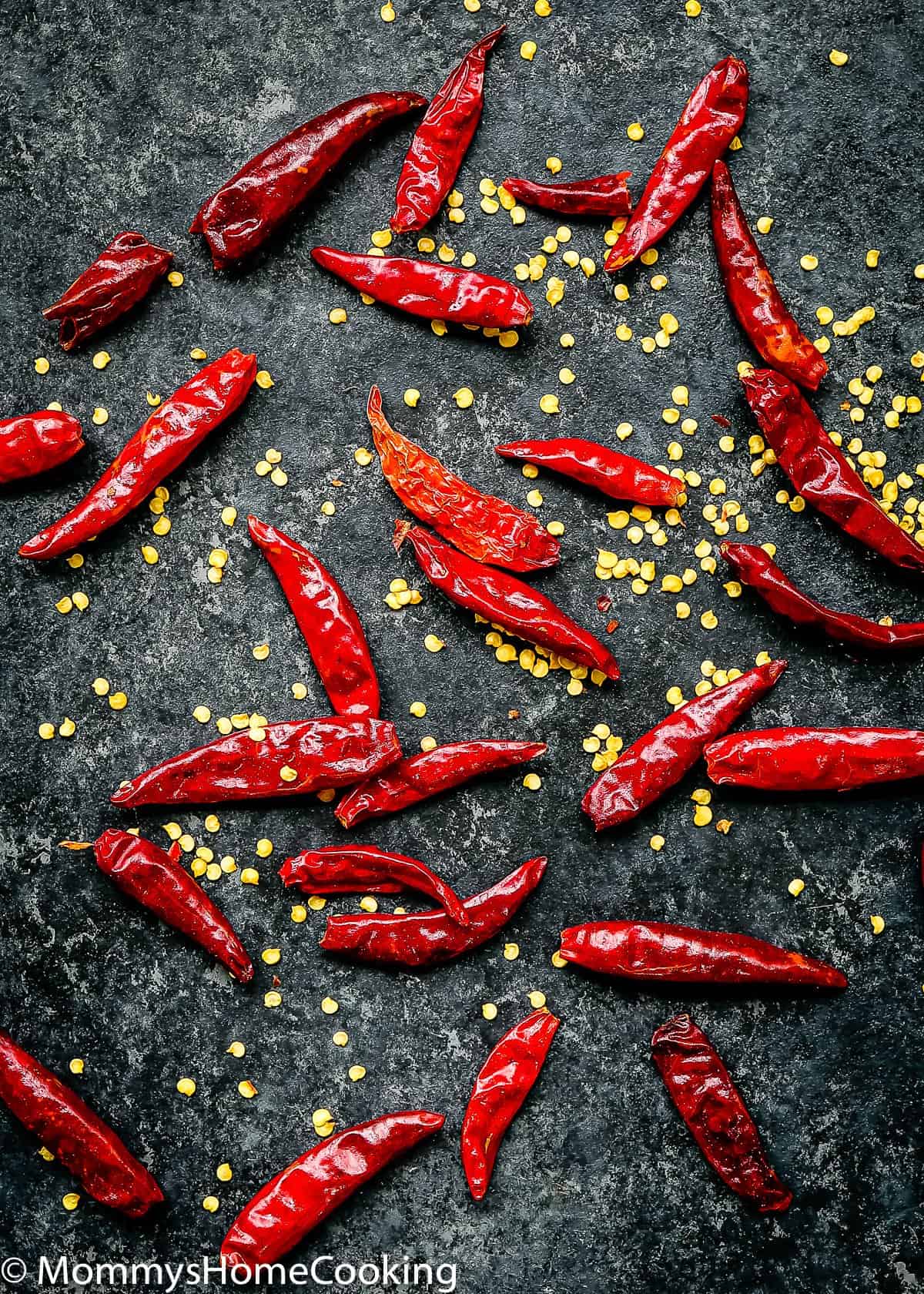 dried red chilies over a black stone