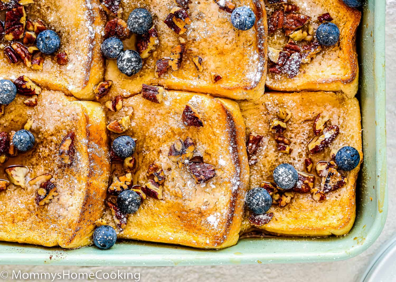 a eggless Eggless French Toast Casserole with pecan an blueberry on top.