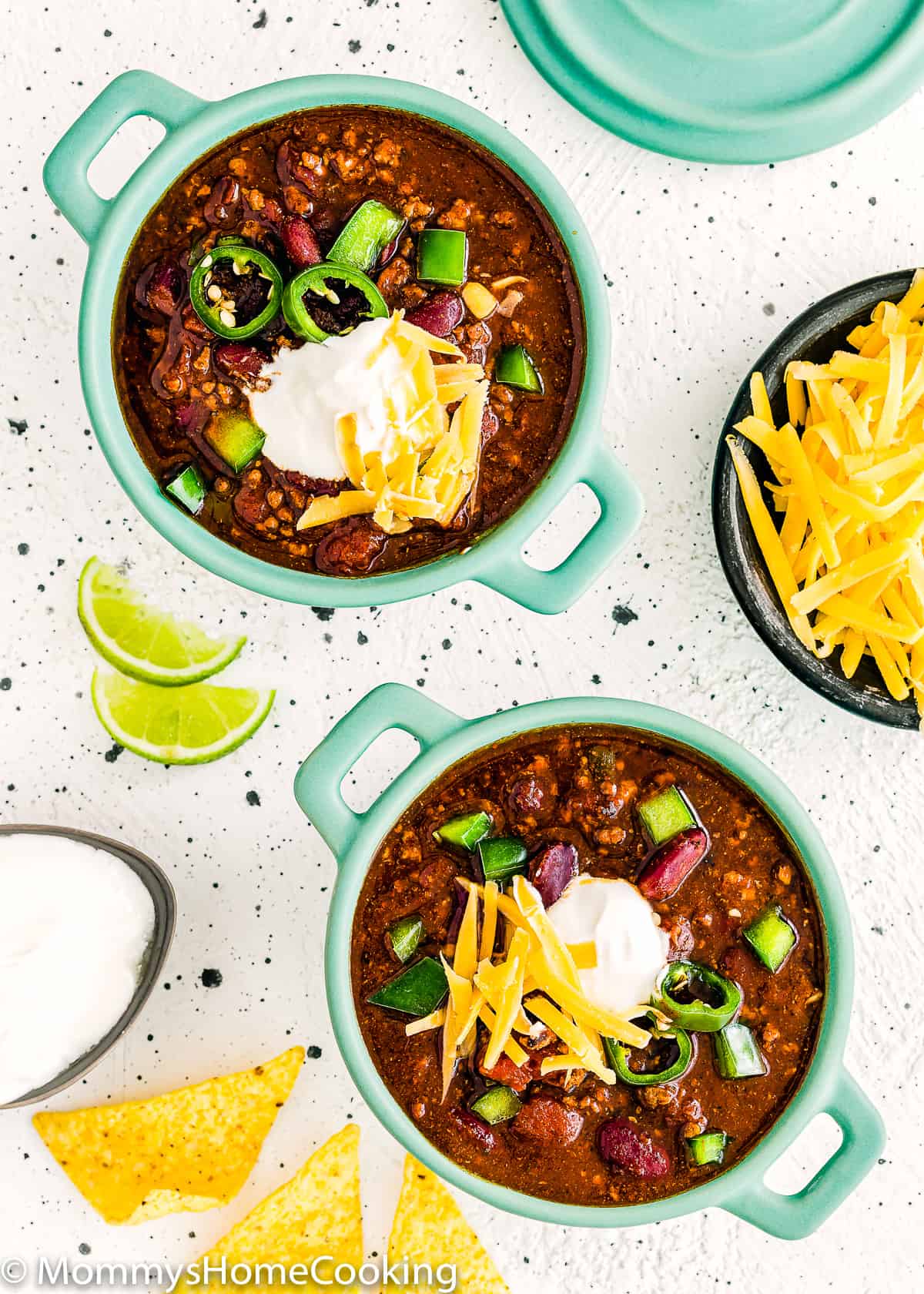 two bowls of instant pot chili with sour cream and cheese