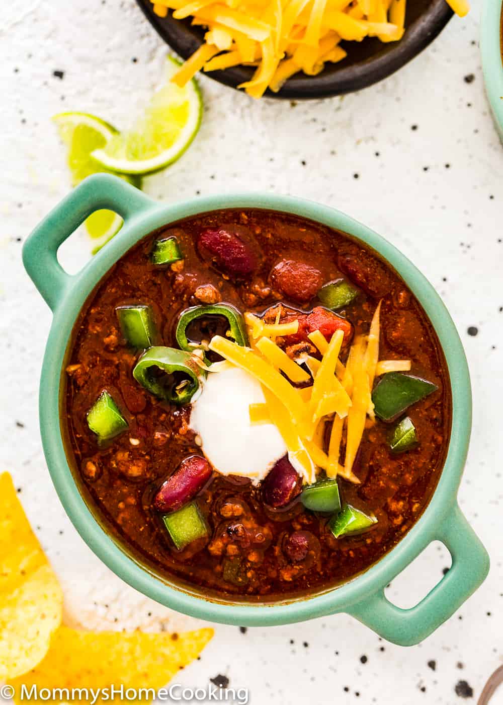 bowl of chili made in the pressure cooker with sour cream and cheese