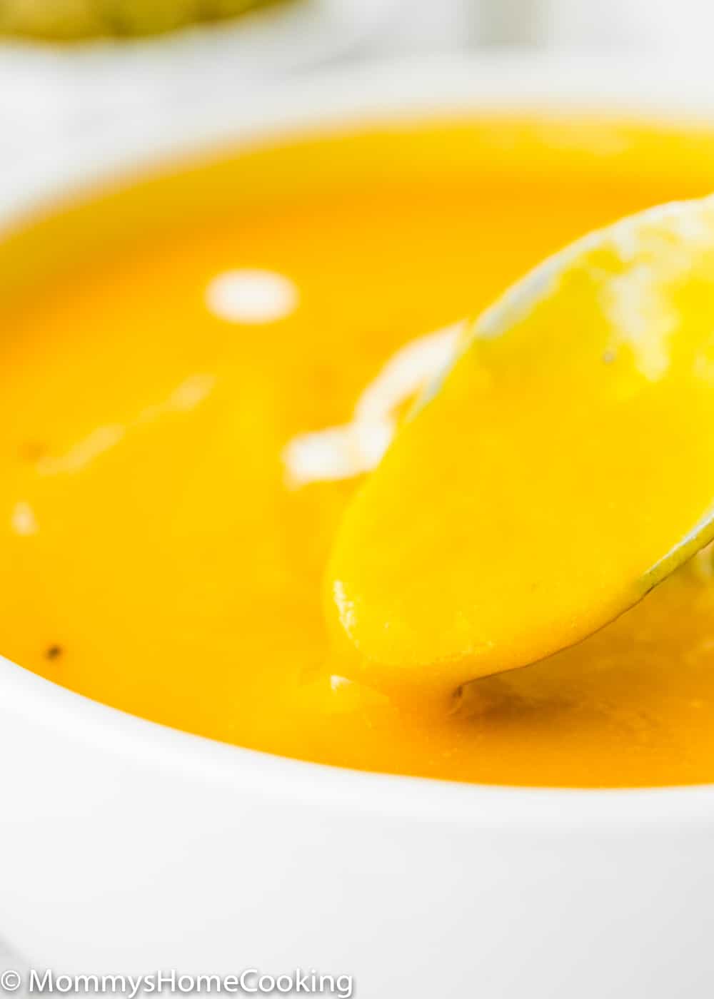 Easy Instant Pot Pumpkin Soup  in a bowl with a spoon