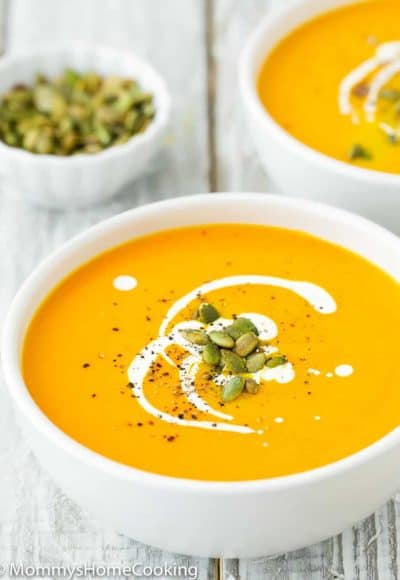 Easy Instant Pot Pumpkin Soup in a bowl with cream and roasted pumpkin seeds