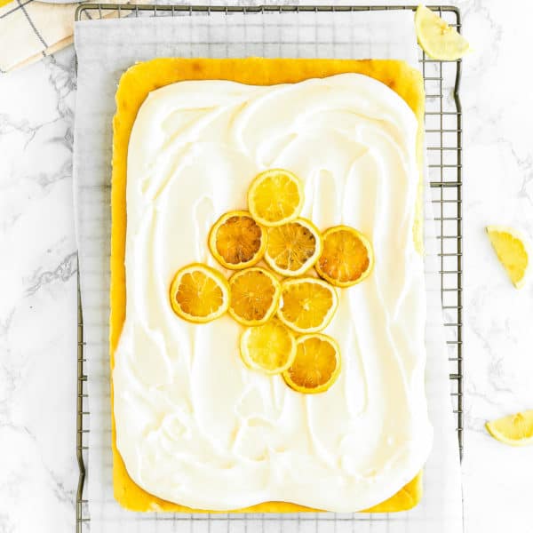 overhead view of an Eggless Lemon Cake with buttercream and candied lemons
