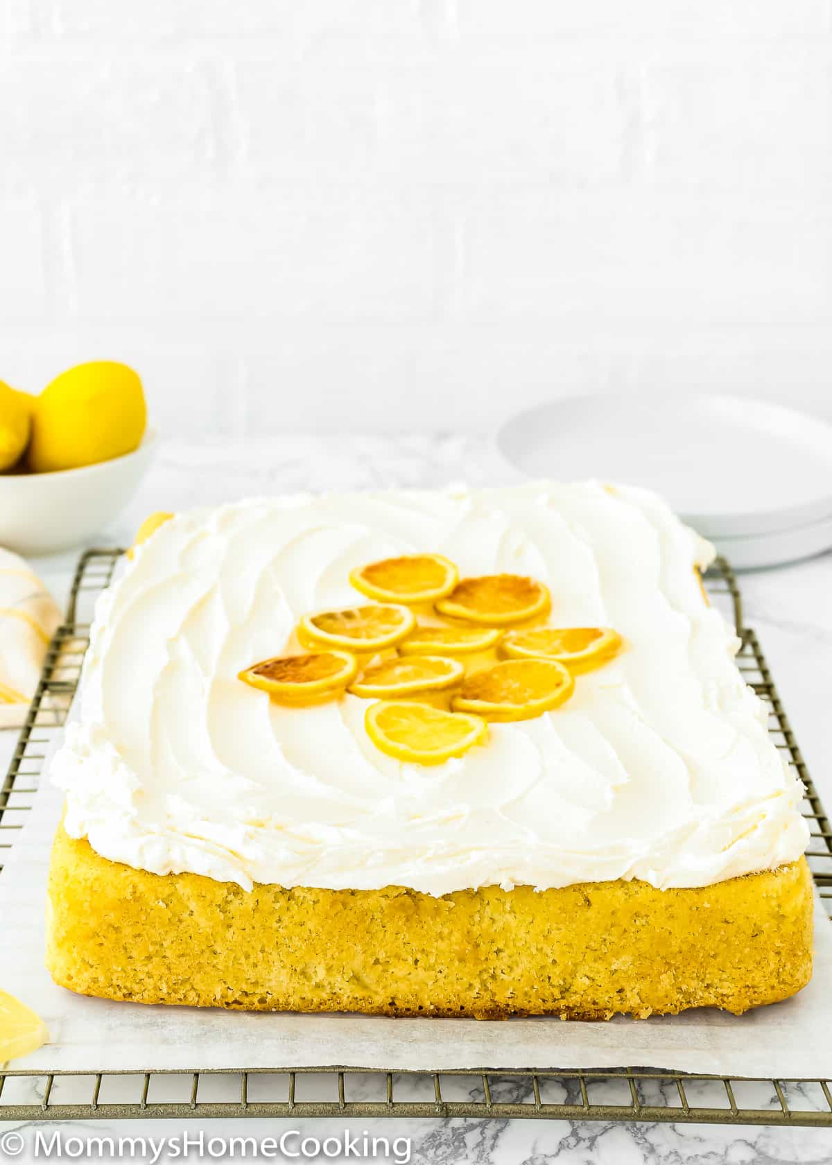Eggless Lemon Cake with lemon butter cream on a cooling rack.