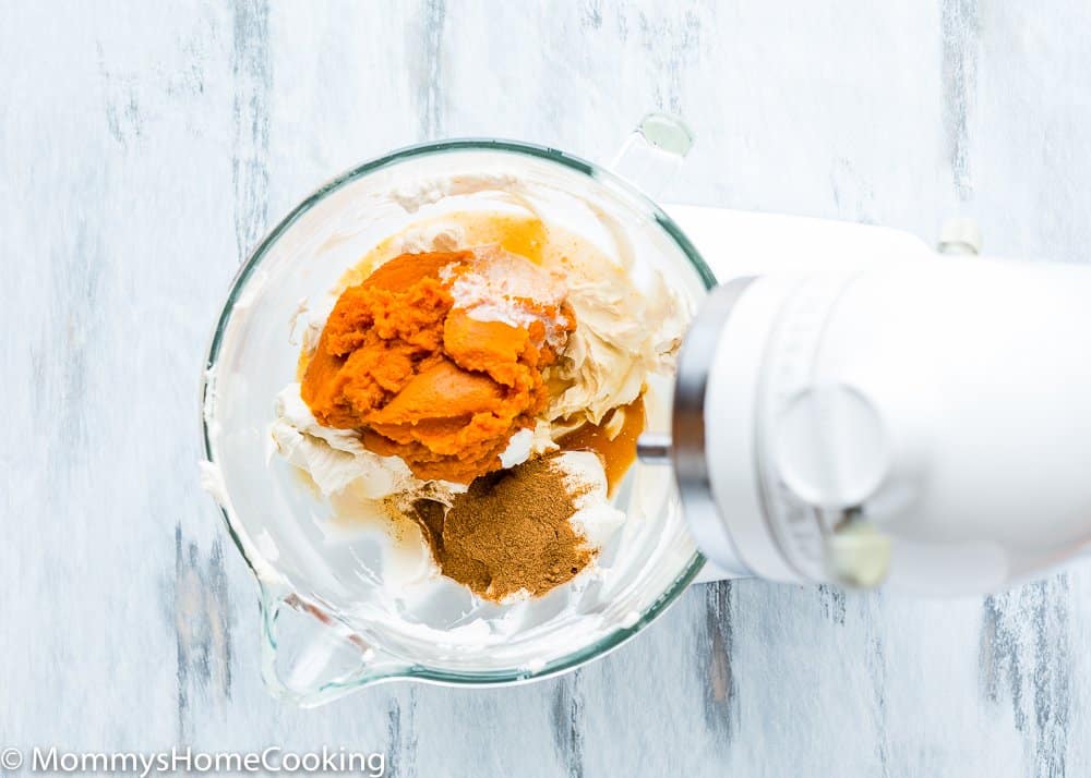 cream cheese, spices, and pumpkin purée  in a stand mixer bowl. 