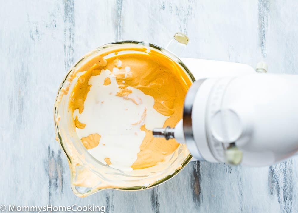 egg-free pumpkin Cheesecake filling with heavy cream in a stand mixer bowl. 