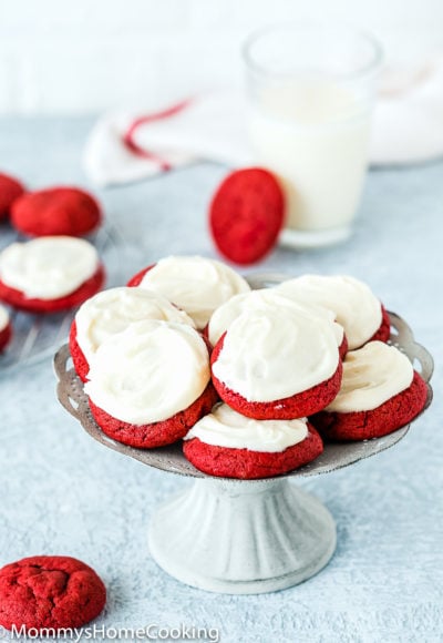 eggless red velvet cookies with cream cheese frosting on a cake stand