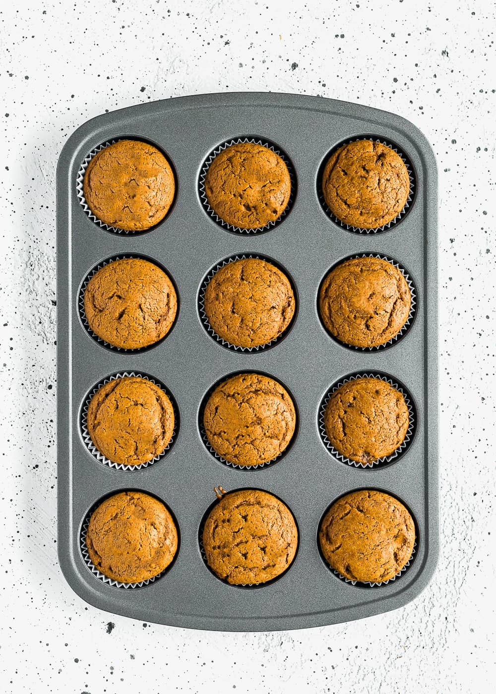 baked Eggless Gingerbread Cupcakes in a cupcake pan.