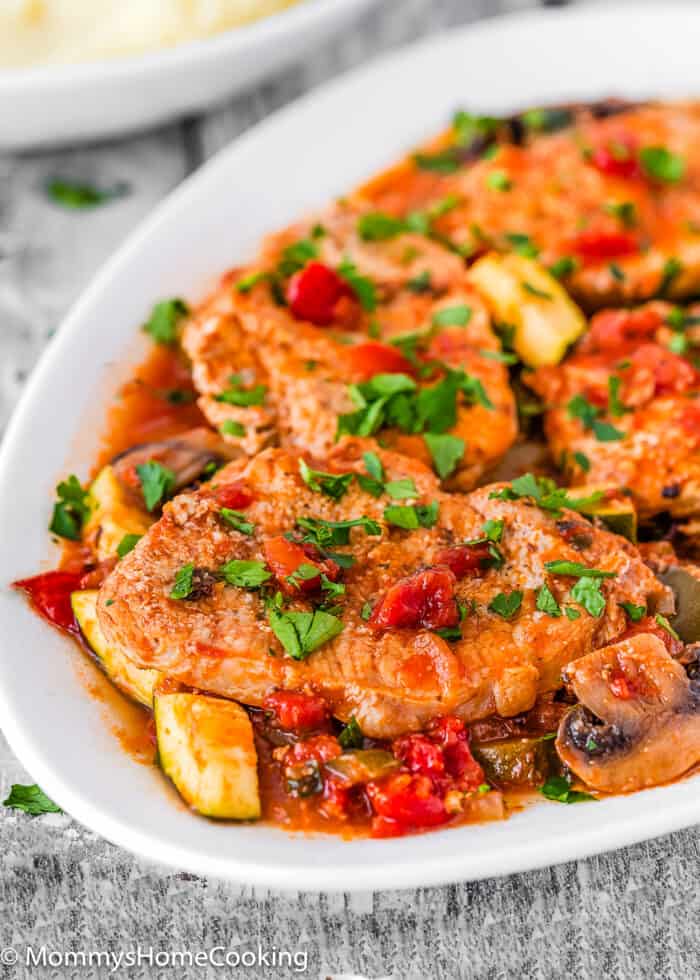 Easy Italian-Style Pork Chops in serving plate chopped parsley.