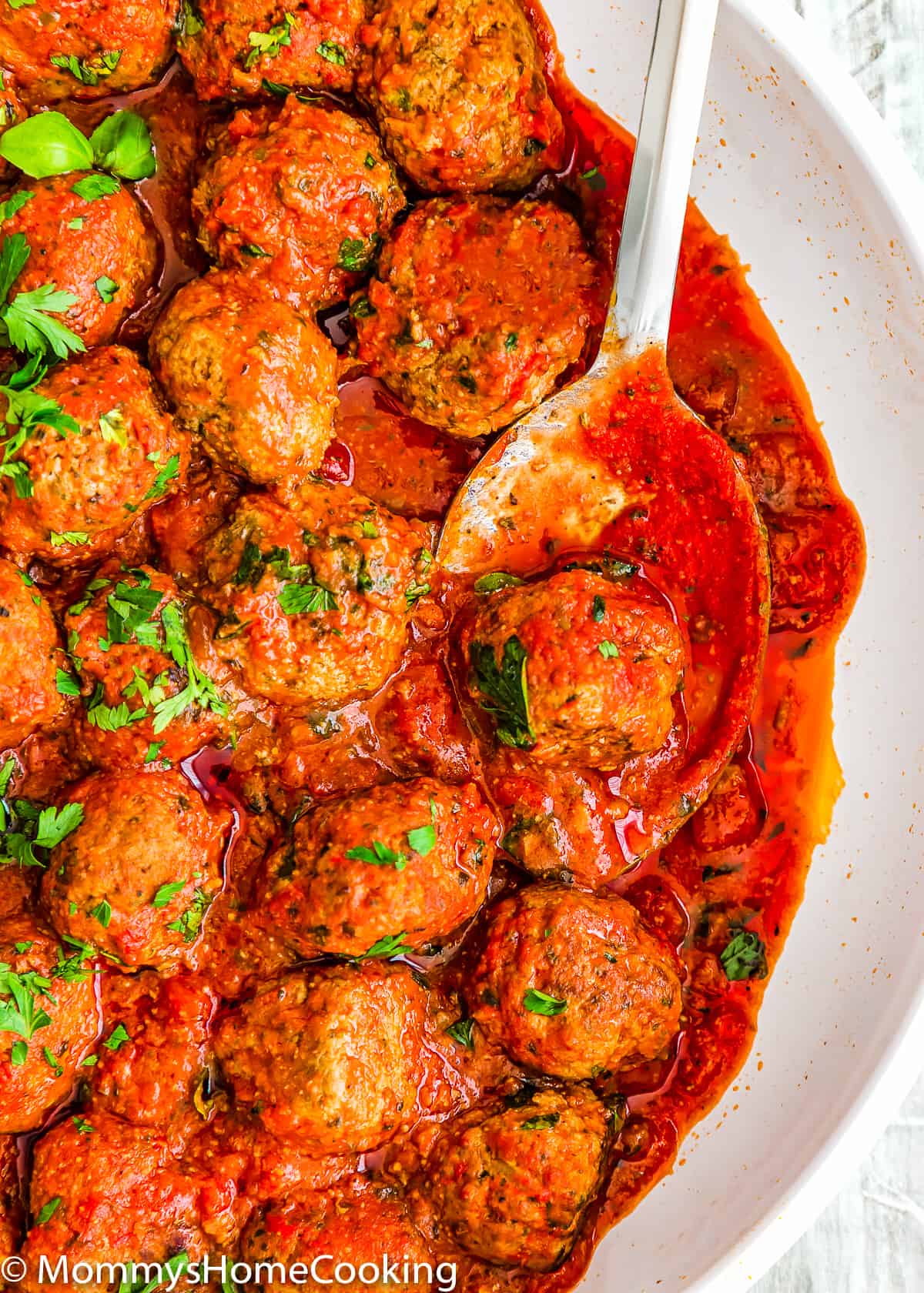Eggless Italian Meatballs in a skillet with a serving spoon
