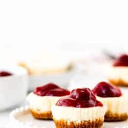 Easy Eggless Mini Cheesecakes with strawberry sauce in a white plate