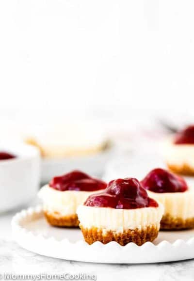 Easy Eggless Mini Cheesecakes with strawberry sauce in a white plate