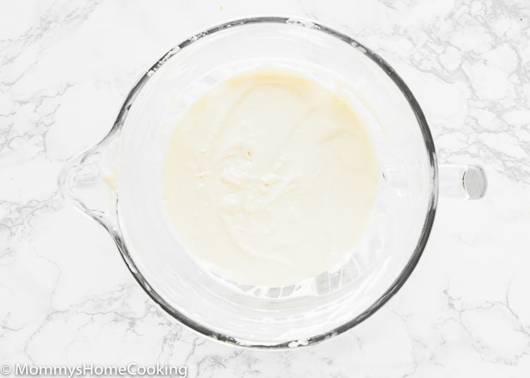 Eggless cheesecake batter in a stand mixer bowl. 