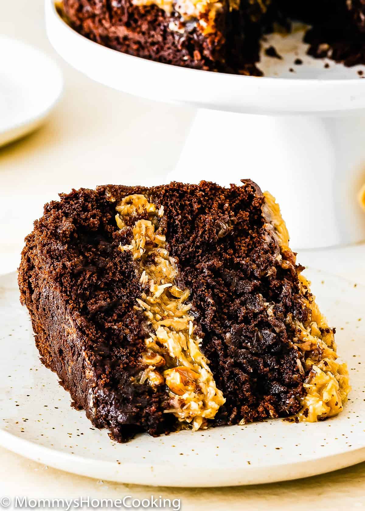slice of Eggless German Chocolate Cake on a white plate