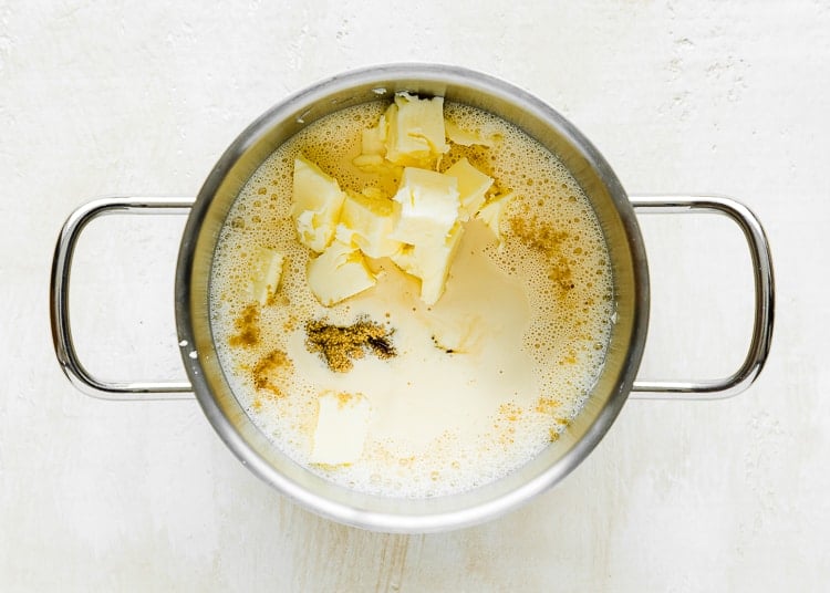 a small pot with evaporated milk, butter, and brown sugar.