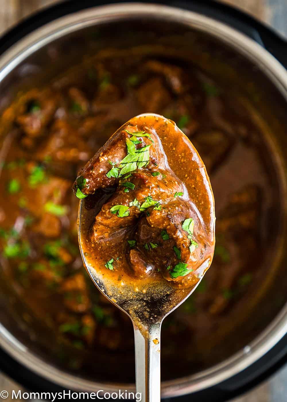 Beef Tips with gravy in a serving spoon