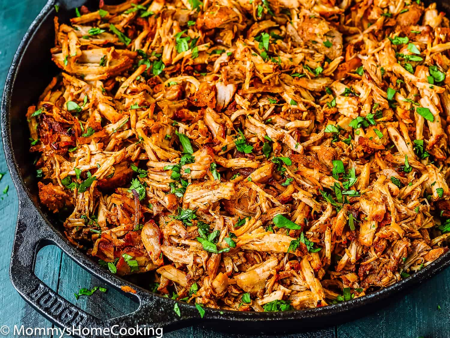 tender Mexican Pulled Pork in a cast iron skillet.