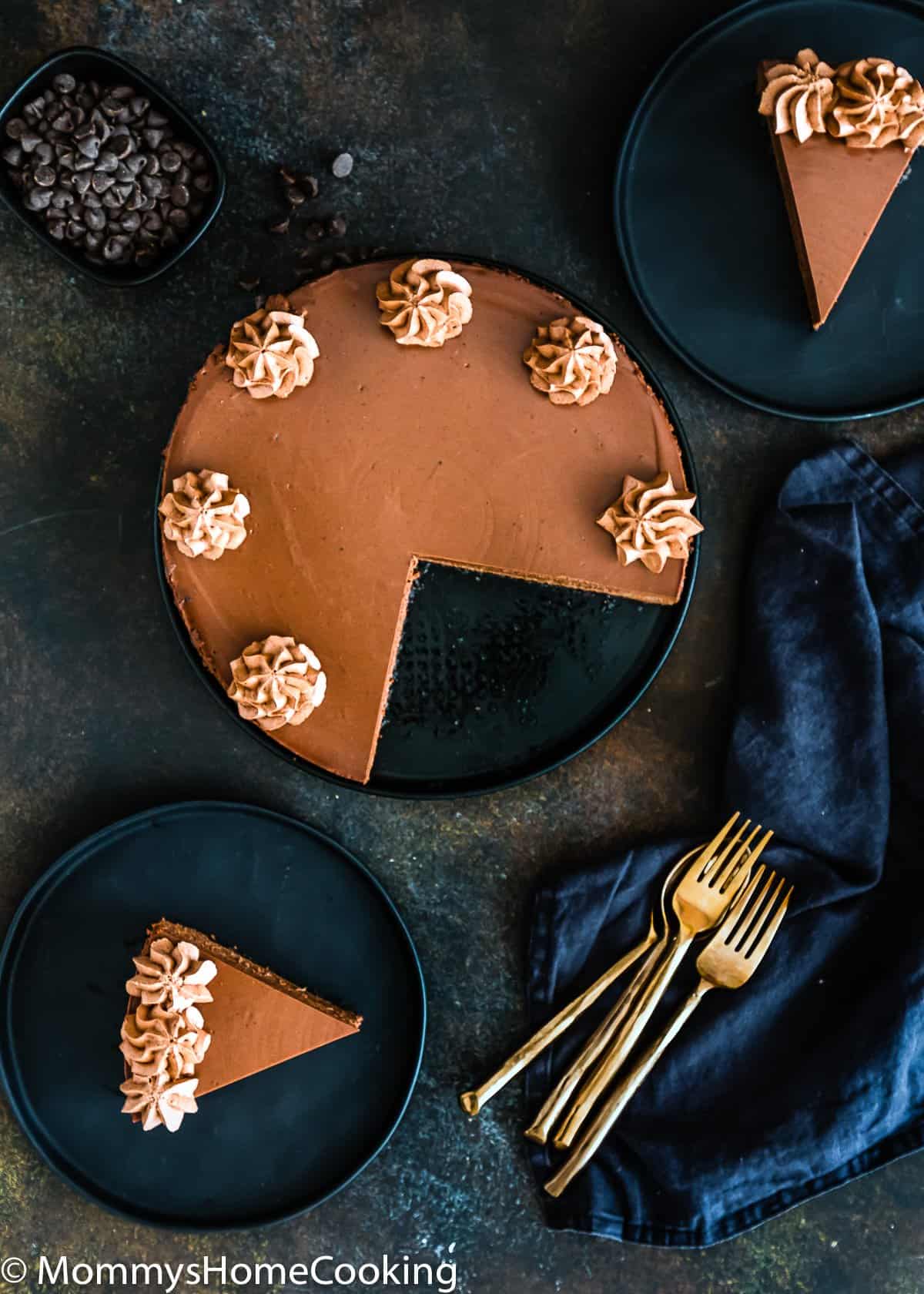 overhead view of an Eggless Chocolate cheesecake in a plate with two slices on the side
