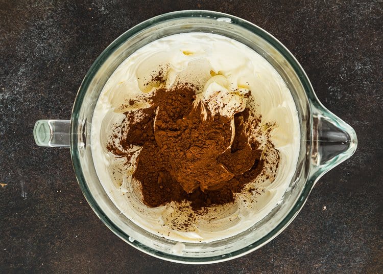 whipped cream cheese with cocoa powder in top. 
