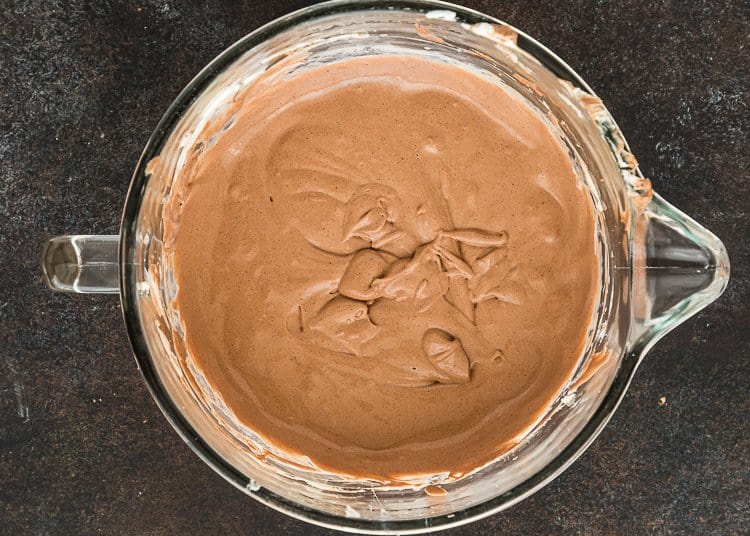 egg-free chocolate batter for cheesecake in a stand mixer bowl.