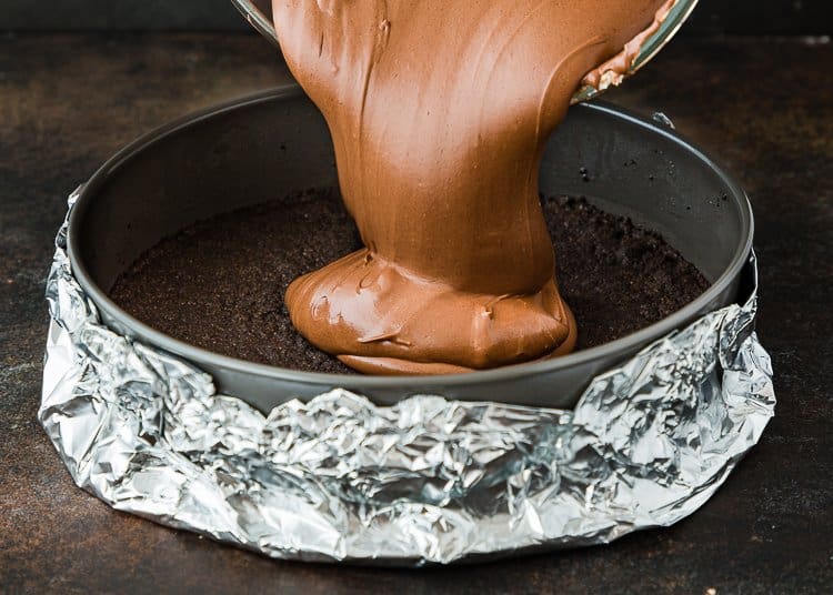egg-free chocolate cheesecake mixture being poured into a springform.