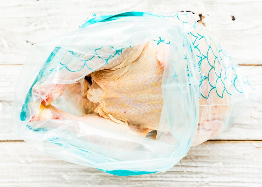 raw whole chicken in a gallon zip-top bag. 