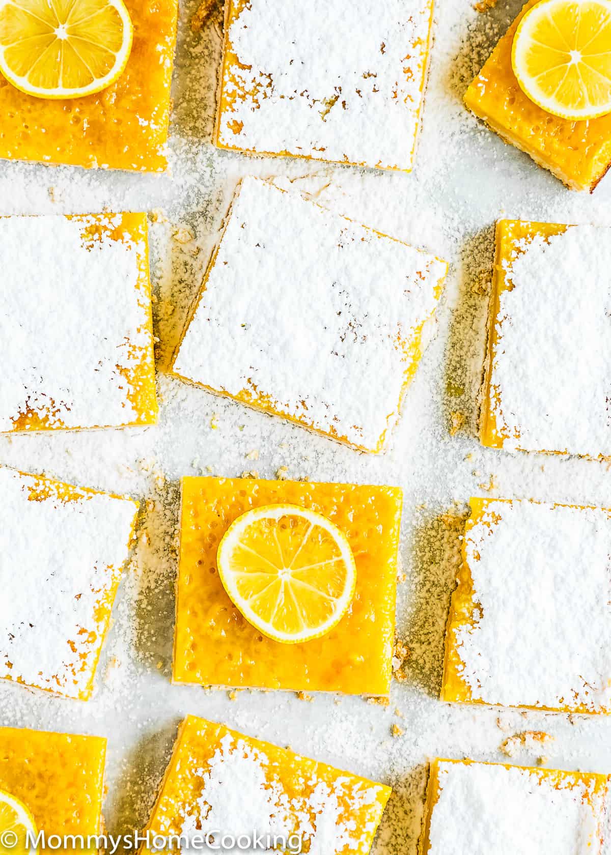eggless lemon bars with powdered sugar and lemon slices. 